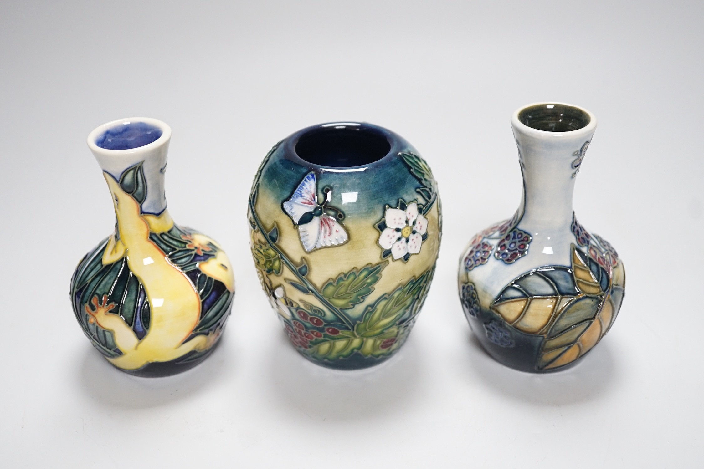 Three boxed Moorcroft small vases, Rarotonga Lizard, Bramble, etc., tallest 10 cm